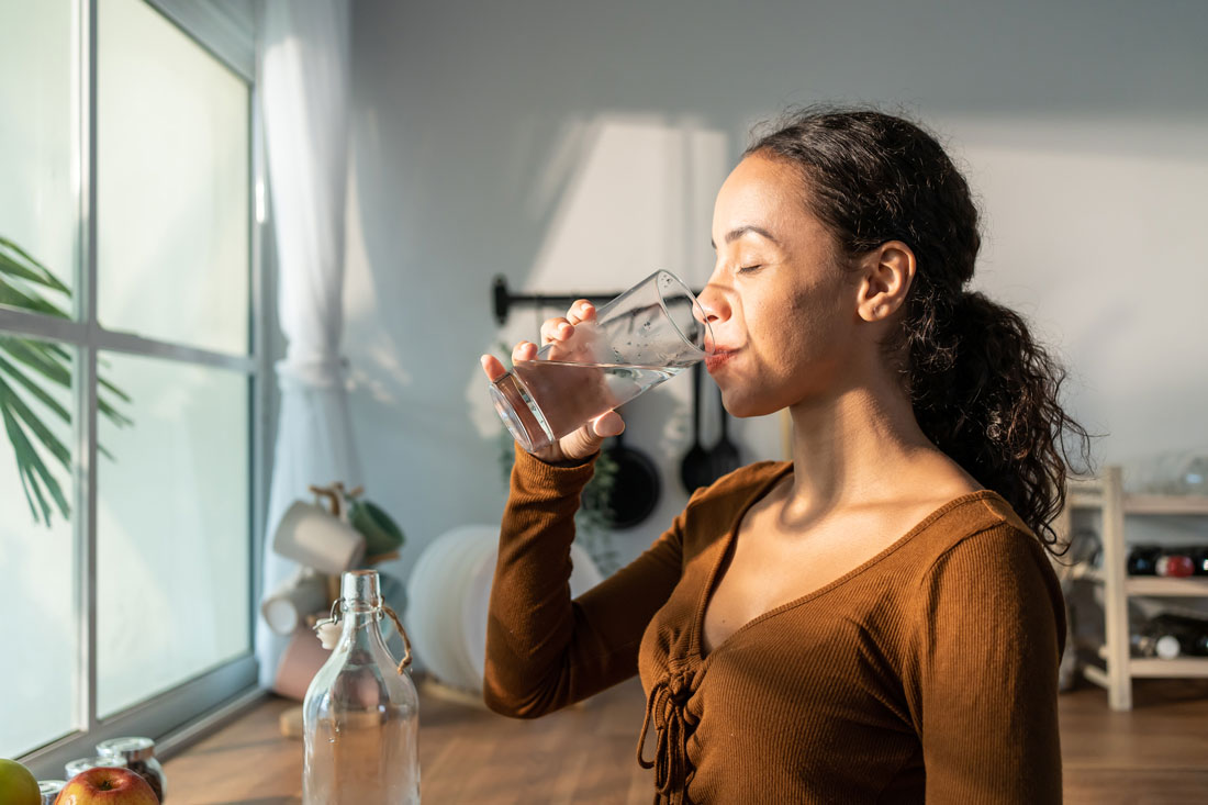 woman-drinking-water-from-home-water-filtration